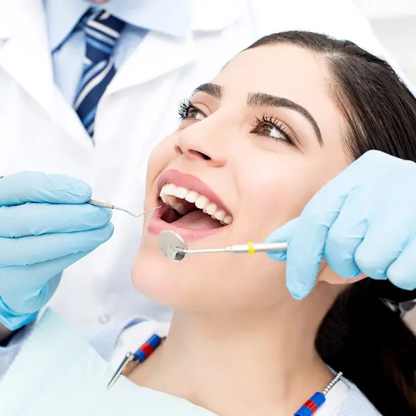 Woman having teeth examined