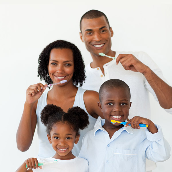 family holding tooth brushes